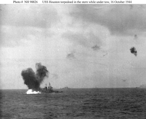 Japanese aerial torpedo hits the ship's starboard quarter, during the afternoon of 16 October 1944. This view shows burning fuel at the base of the torpedo explosion's water column. Houston had been torpedoed amidships on 14 October, while off Formosa, and was under tow by USS Pawnee (ATF 74) when enemy torpedo planes hit her again. USS Canberra (CA 70), also torpedoed off Formosa, is under tow in the distance. The original photograph is in the USS Santa Fe (CL 60) "Log", a very large photo album held by the Navy Department Library. Official U.S. Navy Photograph, from the collections of the Naval Historical Center #NH 98826.