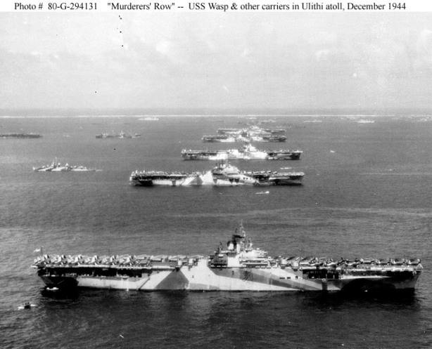 Third Fleet aircraft carriers at anchor in Ulithi Atoll, 8 December 1944, during a break from operations in the Philippines area. The carriers are (from front to back): USS Wasp (CV-18), USS Yorktown (CV-10), USS Hornet (CV-12), USS Hancock (CV-19) and USS Ticonderoga (CV-14). Wasp, Yorktown and Ticonderoga are all painted in camouflage Measure 33, Design 10a. Photographed from a USS Ticonderoga plane. Official U.S. Navy Photograph, now in the collections of the National Archives (Photo #: 80-G-294131).