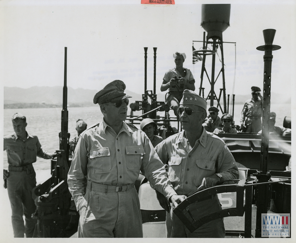 General MacArthur and Lieutenant General Krueger discuss the progress of the Philippine campaign aboard a PT boat in October 1944